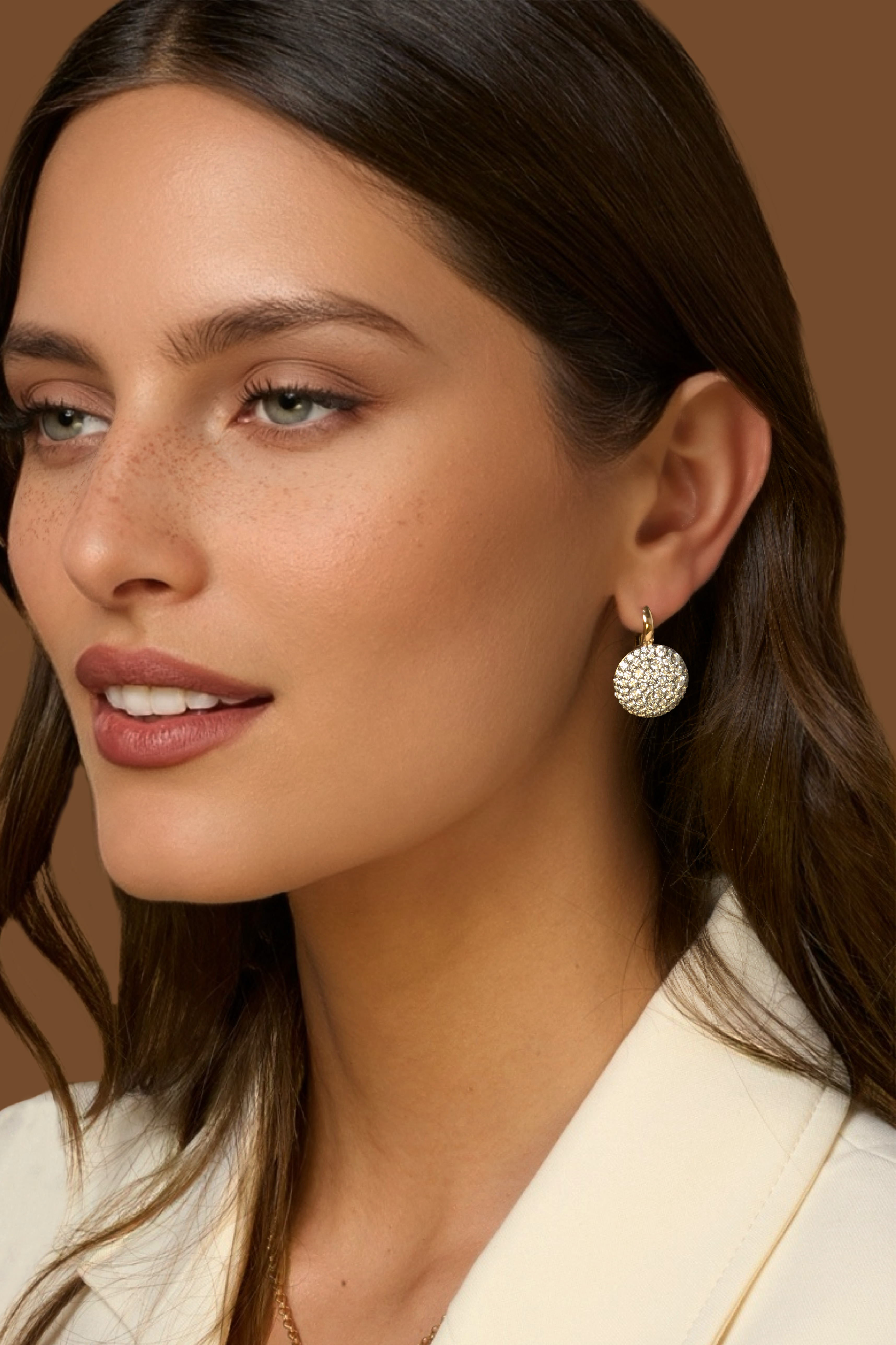 A close-up portrait of a woman wearing the Prima 14mm Leverbacks in yellow gold with round pave diamond drops set in black rhodium.