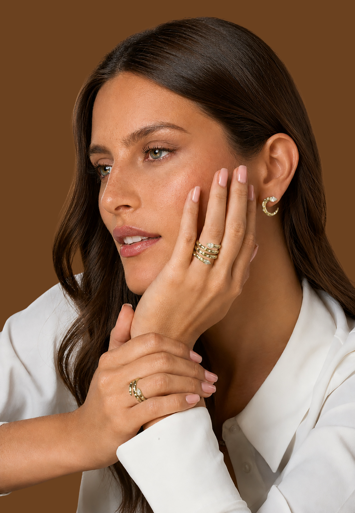 Model wearing 18k yellow gold jewelry featuring a pear-shaped natural diamond and a crescent of burnished round natural diamond accents